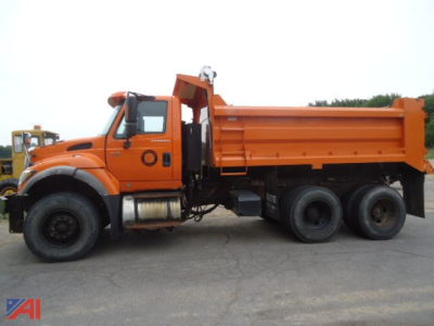 Dump truck side view showing orange International WorkStar 7600 with plow and wing