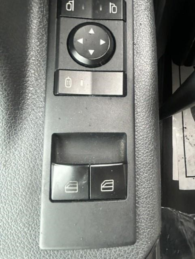 Truck interior showing window/lock controls and two switch buttons on armrest