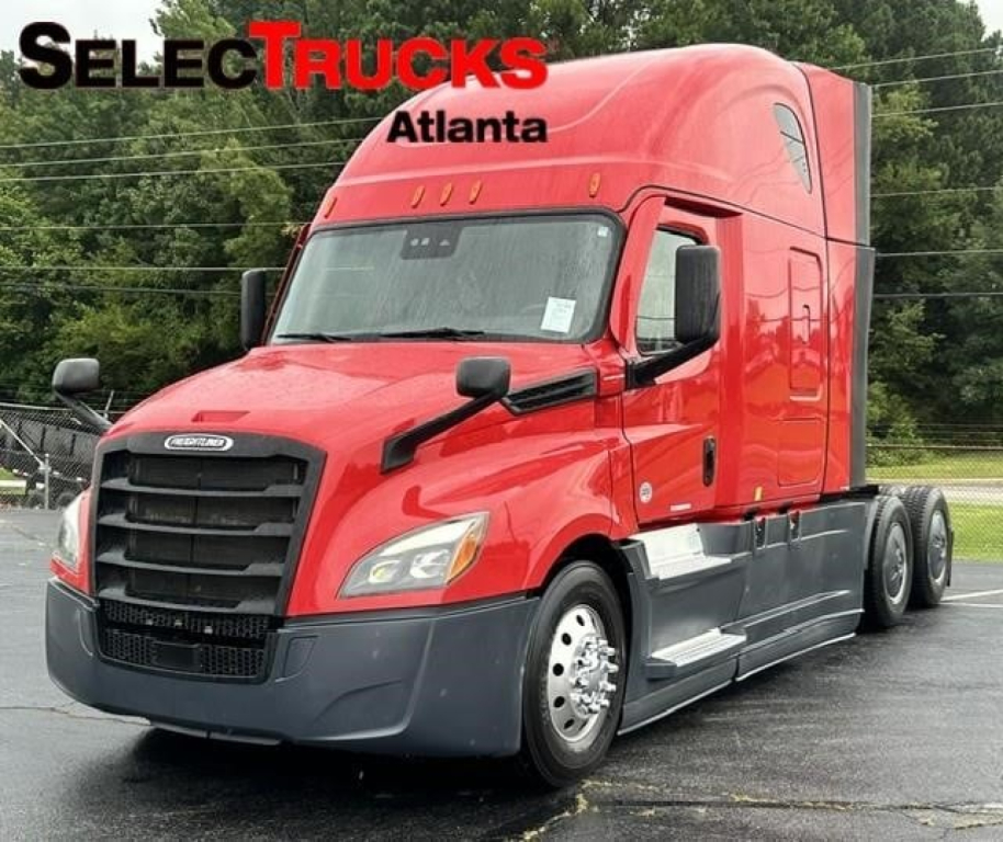 Freightliner Cascadia sleeper tractor in red, front-left view with SelectTrucks Atlanta watermark; chrome mirrors, black grille, headlights, and side steps visible.