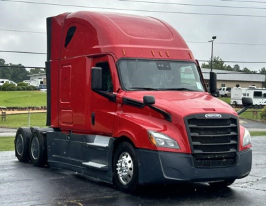 Freightliner Cascadia tractor-trailer in red, front three-quarter view, with sleeper cab and black chassis; appears used.