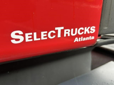 SelectTrucks Atlanta logo on red truck exterior showing partial text and black trim.