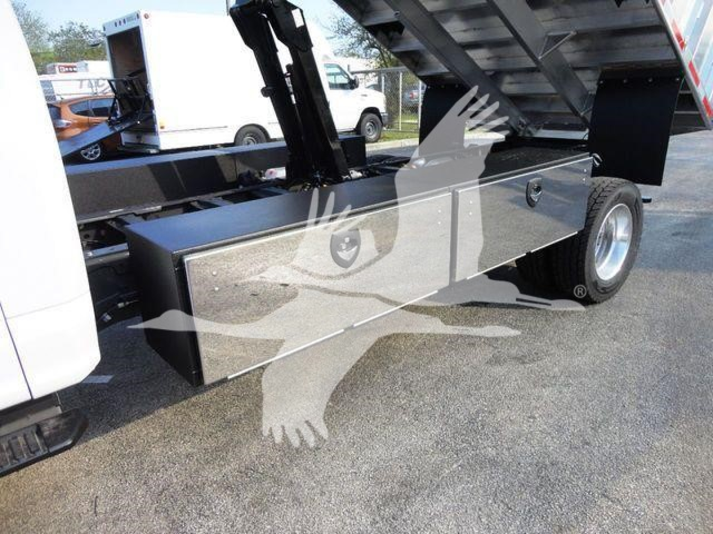 Ford F600 chassis side view showing metal toolbox and wheel in a truck bed setup.
