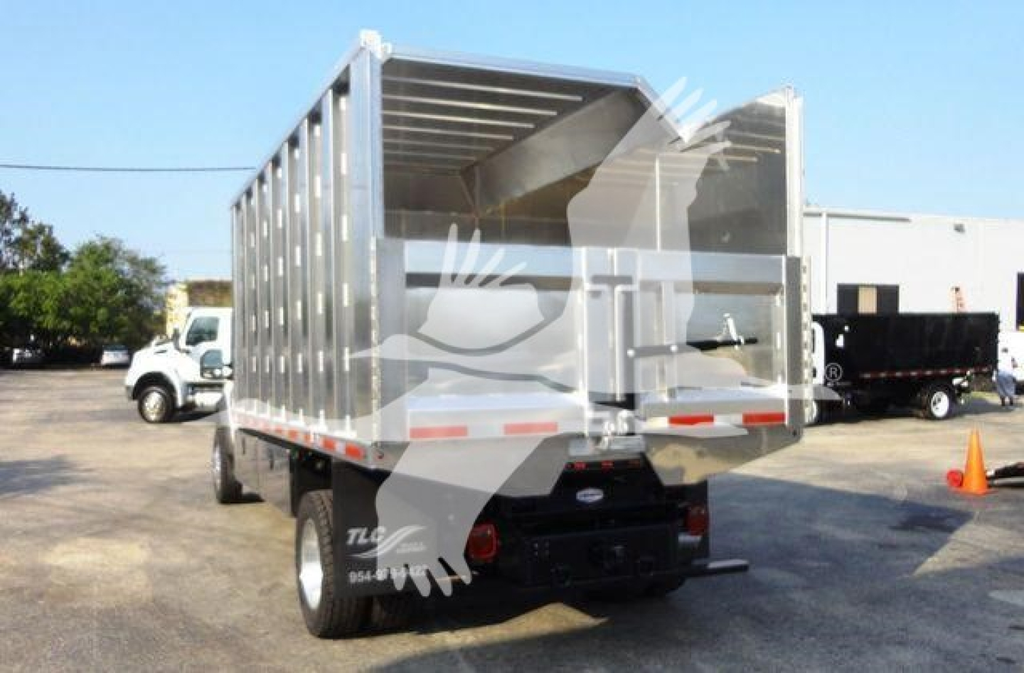 Ford F600 dump truck rear view showing metal cargo bed and dual rear tires.