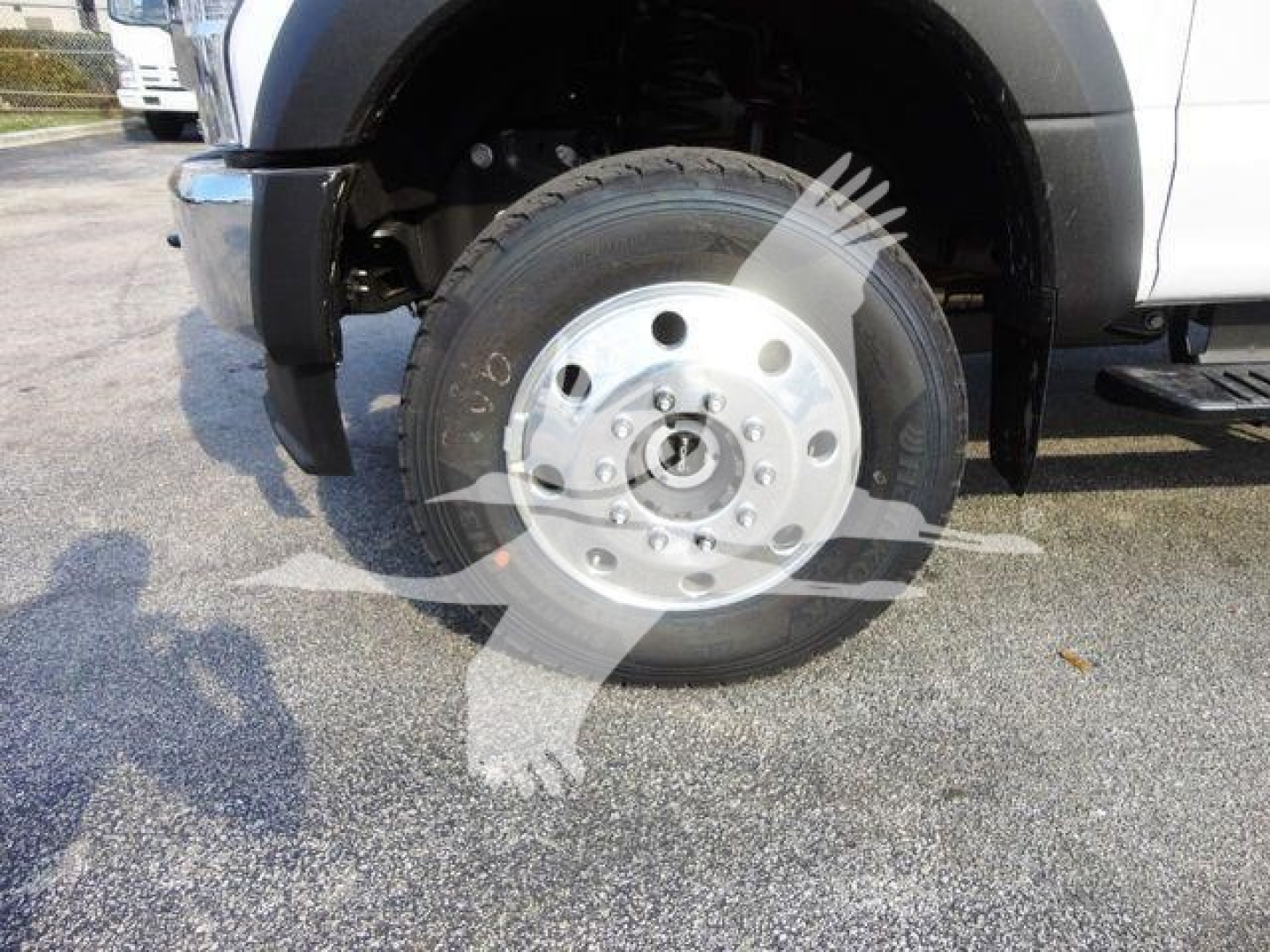 Truck front wheel and hub showing aluminum wheel and tire on Ford F-600 chassis cab for a chipper body.