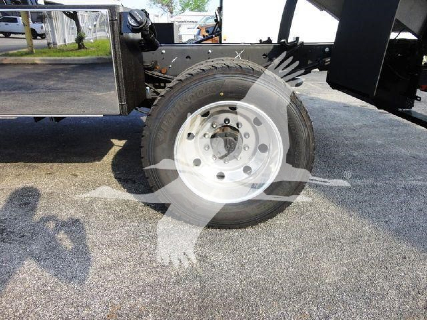Front wheel and spare tire on a 2022 Ford F600 chassis showing wheel hub and frame components.