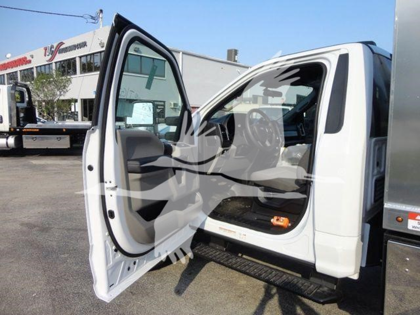 Truck cab with front door open showing interior; no visible text legible on image.