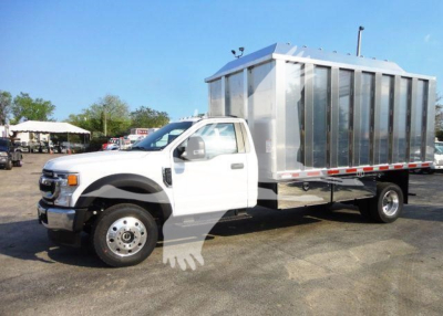 Ford F-Series cab chassis with a large metal box body, white truck on a lot. No visible decals or text legible on the vehicle in this view.