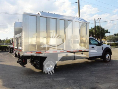 Ford F600 chipper truck with aluminum dump body and white cab, side view showing dual rear wheels and front chrome bumper.