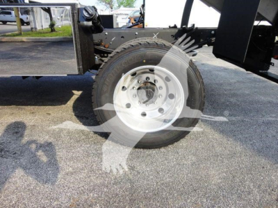 Front wheel and spare tire on a 2022 Ford F600 chassis showing wheel hub and frame components.