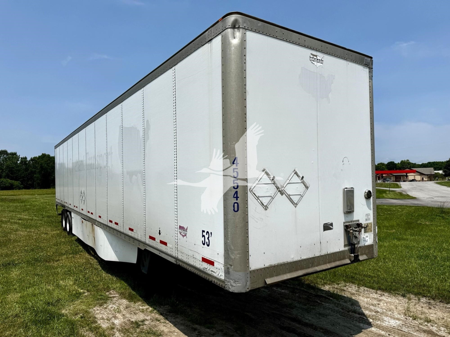 Trailer side and rear of a white 2017 Wabash dry van trailer showing side panel details, NCW codes 45 54 0 and 53' on the lower side, and corner rear with misaligned doors.