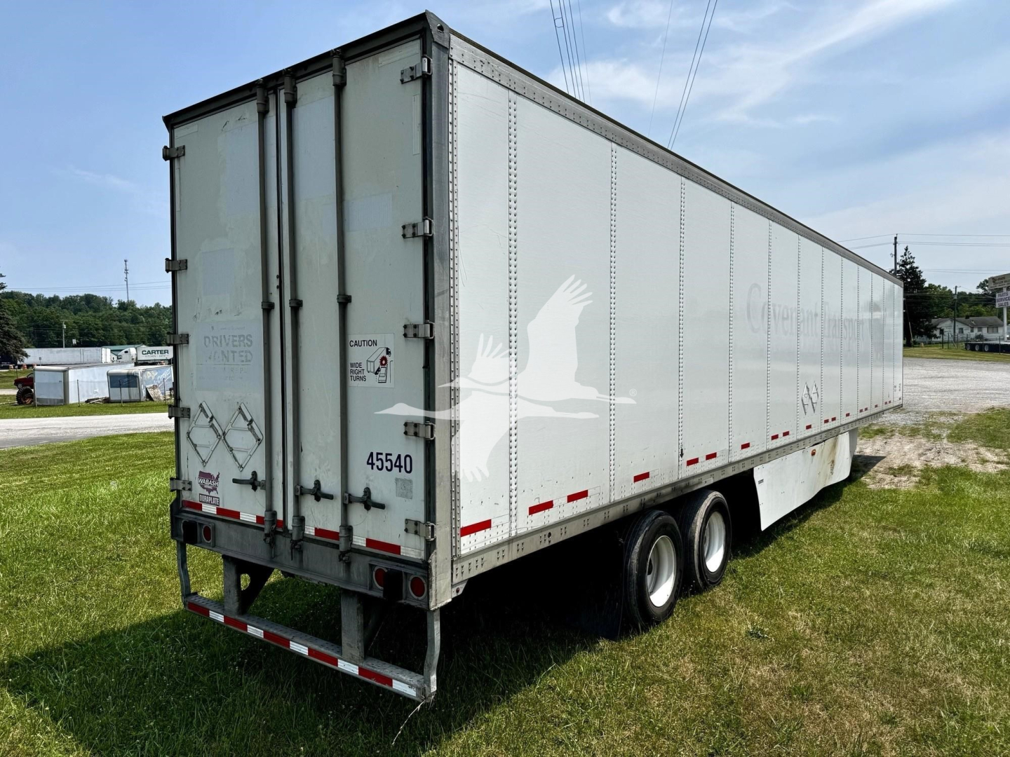 2017 Wabash dry van trailer side and rear view showing triple-axle configuration and rear doors.