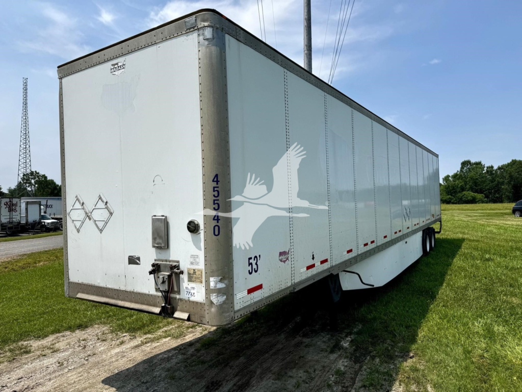 Box trailer with rear doors, side markings, and numbers: 45540 vertical on rear corner; 53" height marking near side; small diamond placard; rear frame hitch and lock mechanism; taillight and reflectors along lower edge.