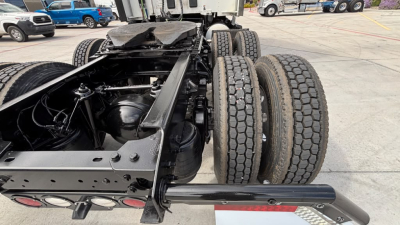 Kenworth T680 chassis showing rear dual-axle setup and suspension with visible tires and frame; no engine bay visible.