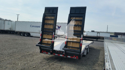 Trailer rear view showing loading ramps and deck with dual ramps raised, flatbed with black frame and red/white reflectors.