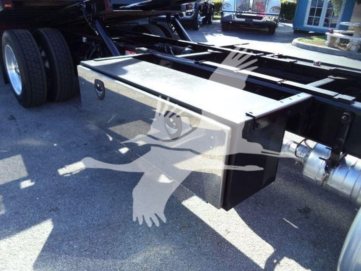 Peterbilt 337 rollback truck chassis curbside view showing rectangular aluminum toolbox mounted under frame