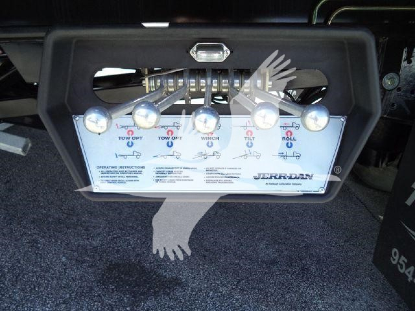 Trucks equipment control panel showing multiple labeled levers and switches with Jerrdan branding on a rollback tow unit control console