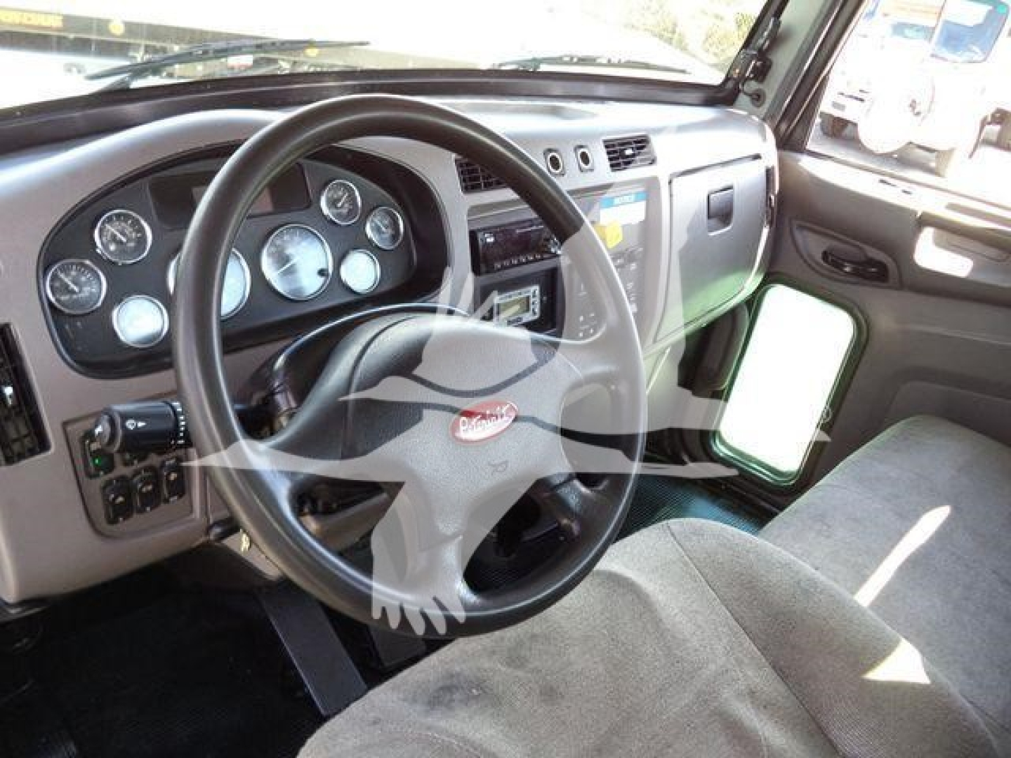 Peterbilt truck interior dashboard with steering wheel and gauges visible