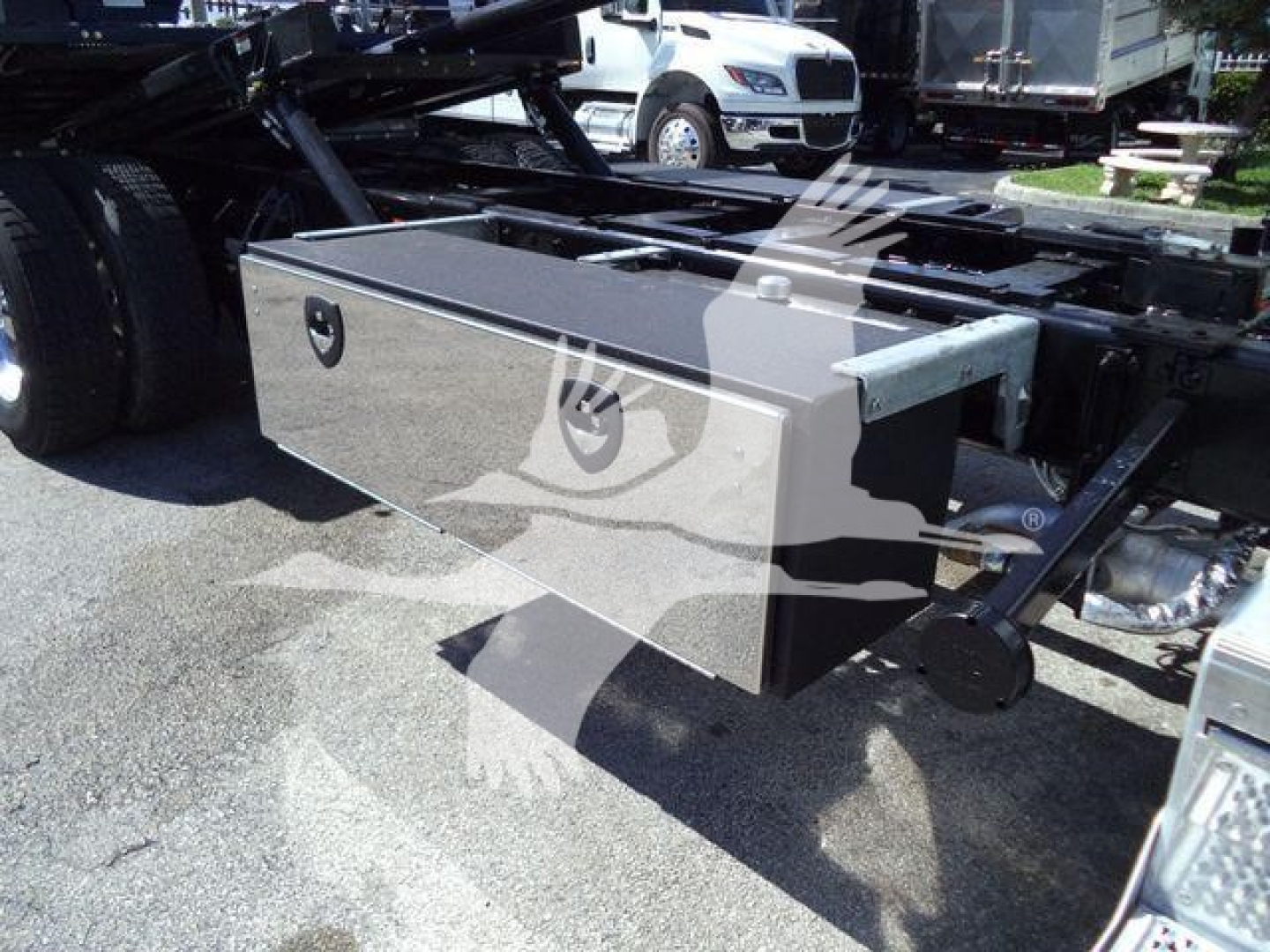 Peterbilt 337 rollback truck with a metal storage box mounted on frame