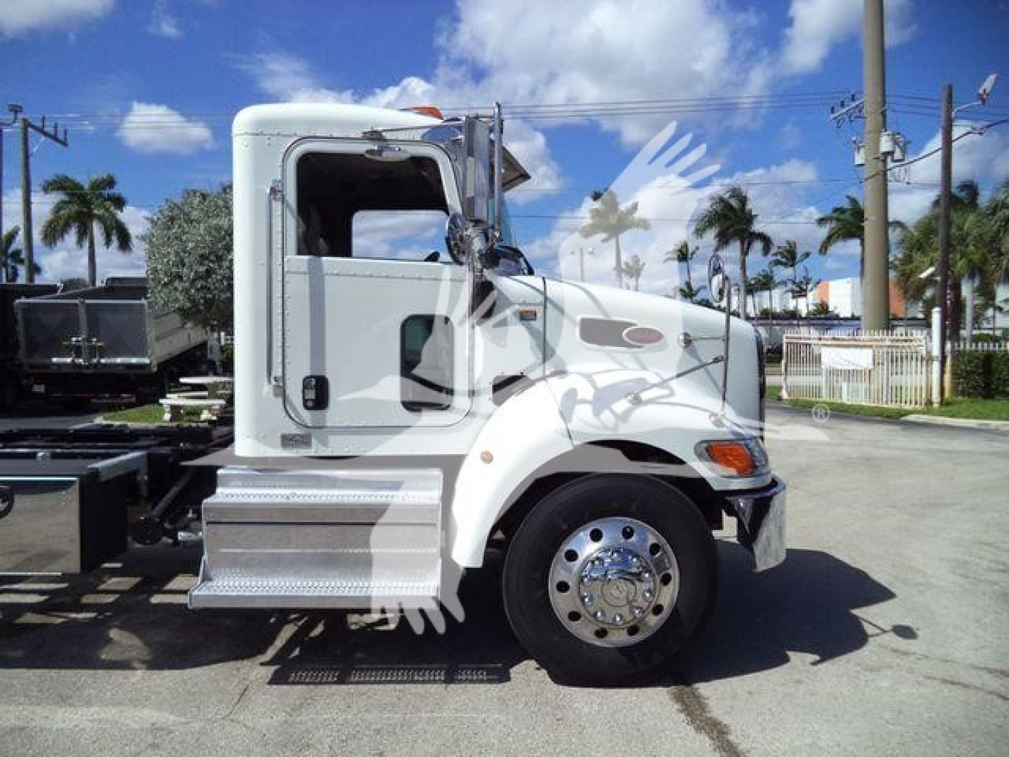 Peterbilt 337 rollback truck side view showing cab and front wheel