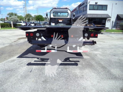 Peterbilt 337 rollback tow truck rear view showing flatbed and taillights.