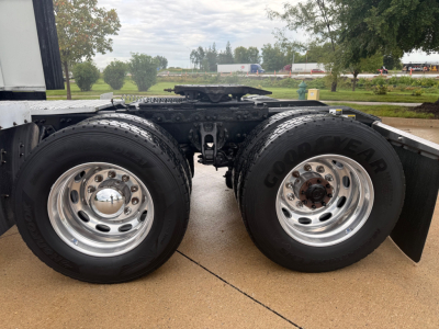 Truck axle and dual rear wheels on Peterbilt 579 chassis showing Goodyear tires and polished rims.