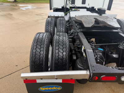 Peterbilt 579 chassis rear with dual rear axles and Speedco badge on tow carrier, showing tires and undercarriage components.