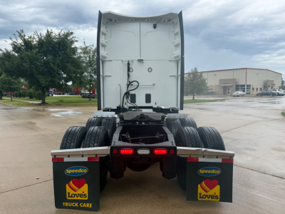 Peterbilt 579 truck rear view showing sleeper cab and dual rear axles with mud flaps and Love's branding.