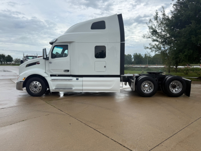 Peterbilt 579 tractor in side view showing sleeper cab and truck chassis with dual rear axles.
