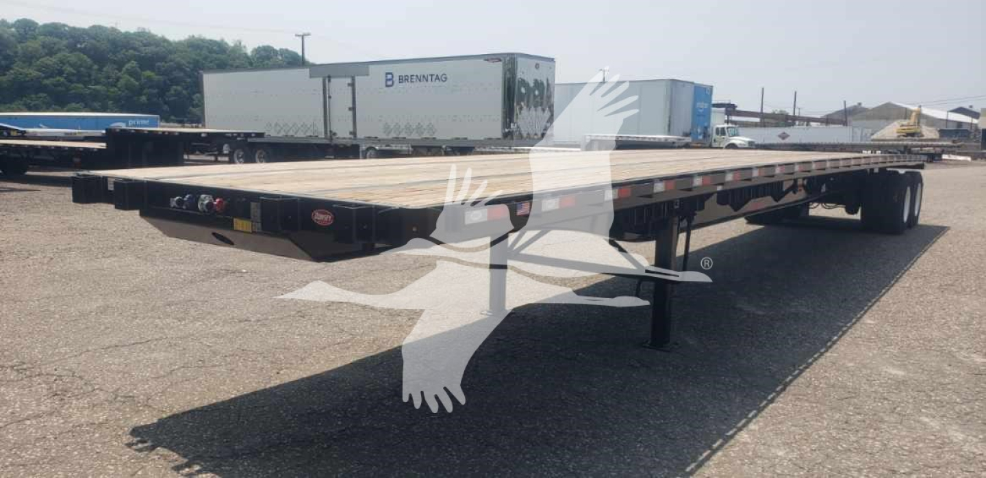 Flatbed trailer with sliding tandem showing steel deck and landing gear, no visible rider text.