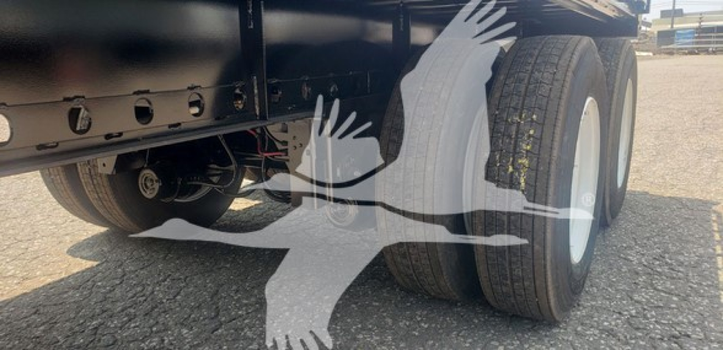 Dorsey air sliding tandem trailer wheel area with dual tires and undercarriage visible.