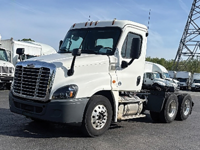Freightliner Cascadia125 tractor cab in a truck lot showing front and side view with white paint.