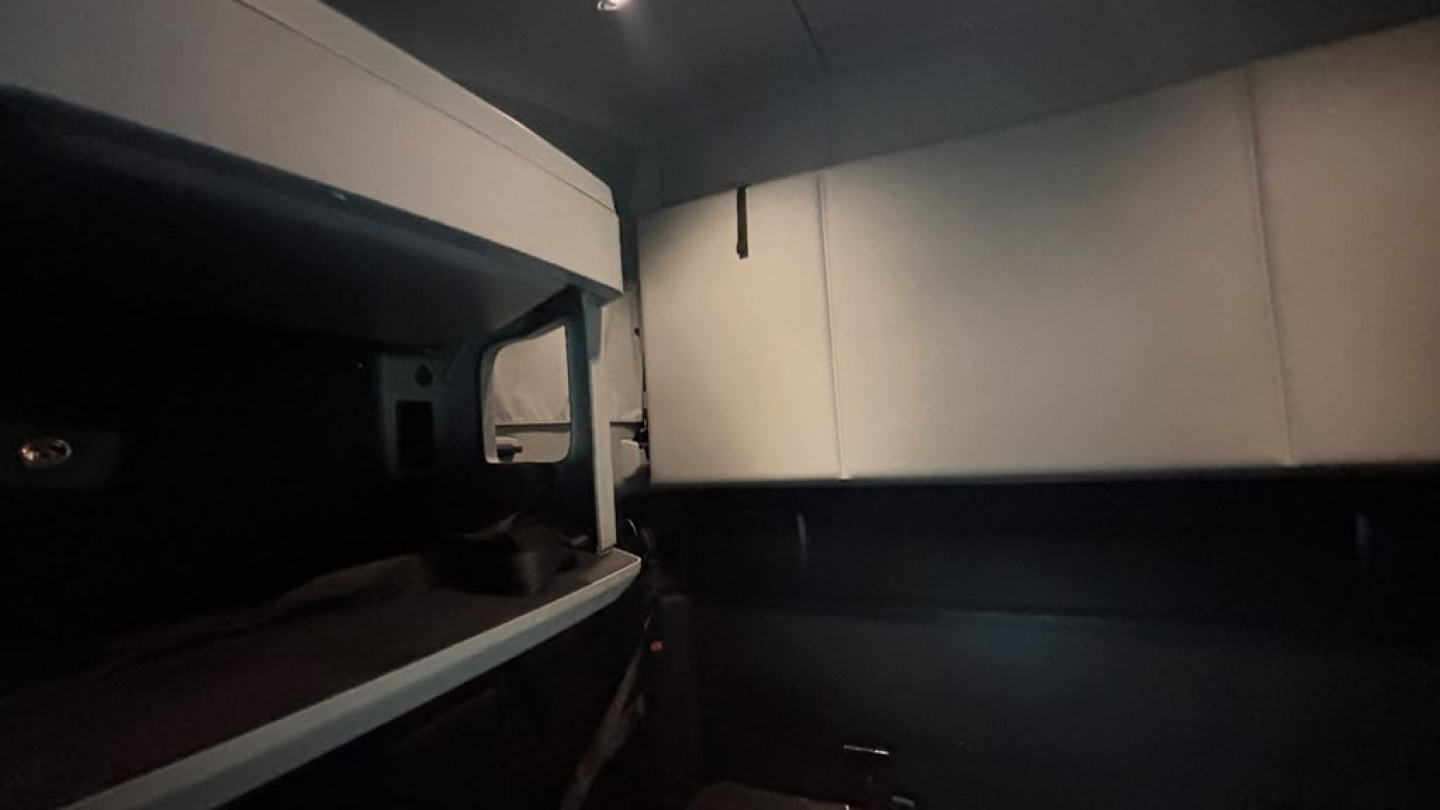 Cab interior of a 2024 Kenworth T680 sleeper truck showing dashboard area and seating with minimal view of side panels.