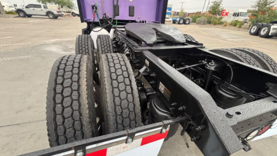 Kenworth T680 truck rear chassis with dual rear axles and rugged tires showing undercarriage view.