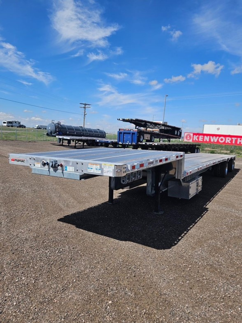 Manac Darkwing 53' drop deck trailer in an outdoor lot showing top deck with mid-axle and landing gear, side decals, and drop deck rails.