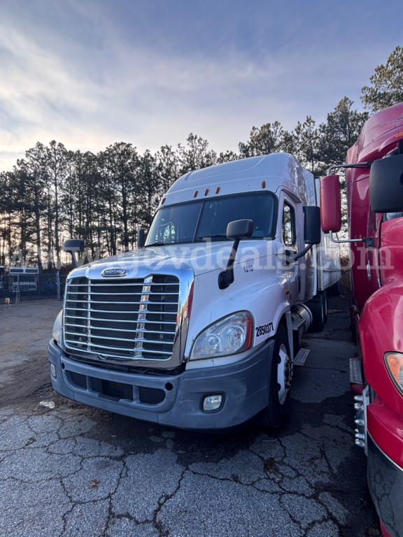 Box truck front view showing Freightliner Cascadia 125 with chrome grille and white cab in-service on asphalt lot.