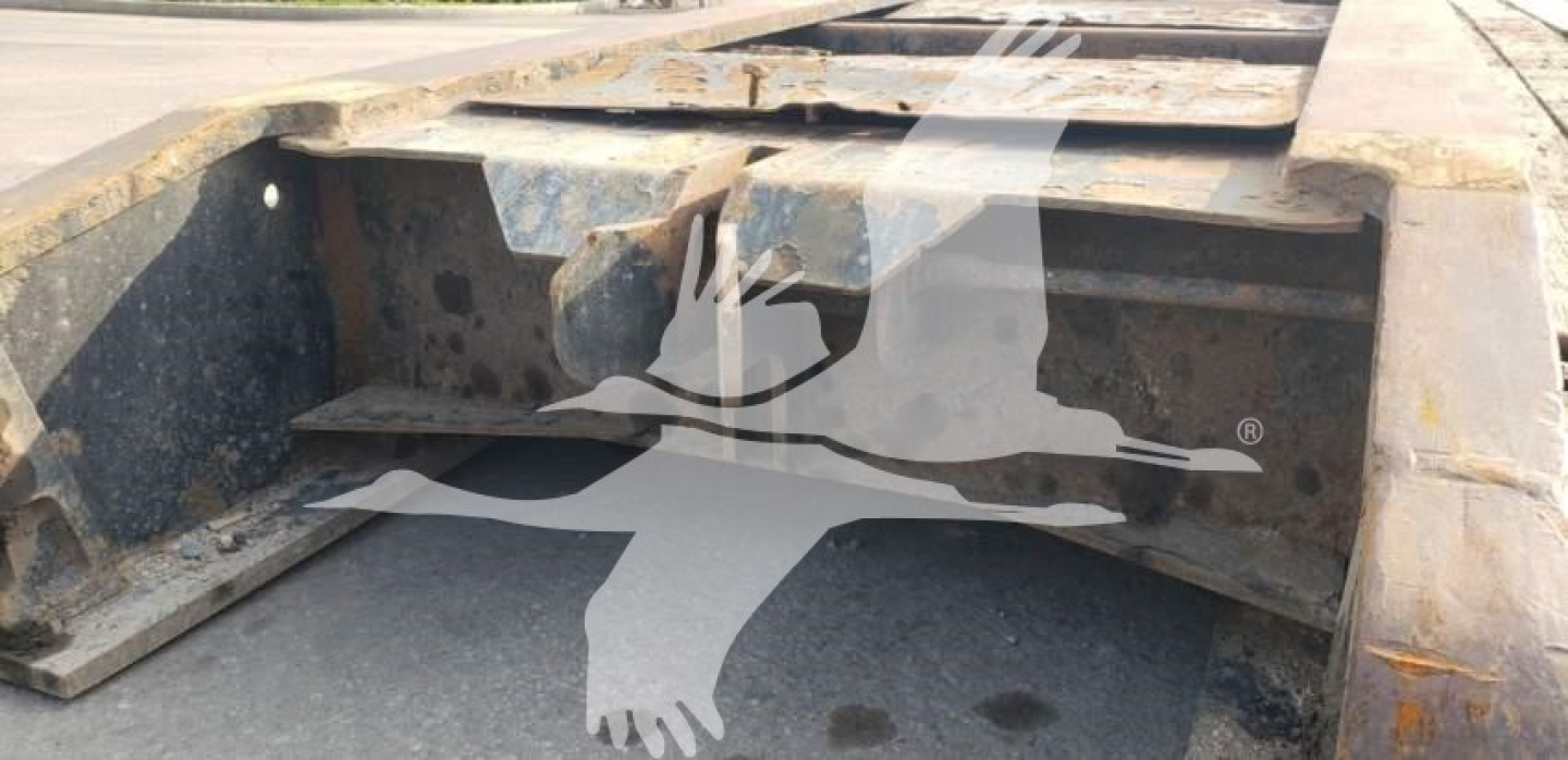  Fontaine 55H-DSR lowboy trailer chassis view showing steel I-beam and deck frame with rust on surface.