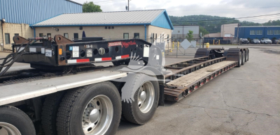 Fontaine 55H-DSR lowboy trailer showing deck and dual rear axles with tires and metal components visible.