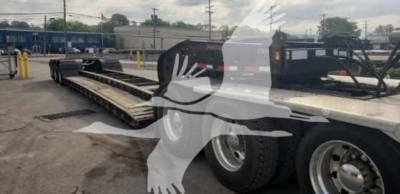 55H-DSR Fontaine lowboy trailer showing dual rear axles and flatbed with reflective tape and wheel rims.