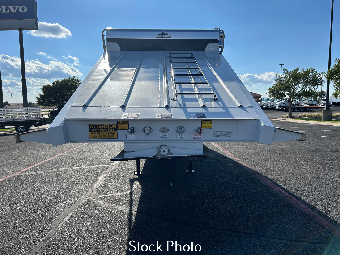 Dump trailer tailgate view showing SLP sheets and ladder, with warning labels and pins.