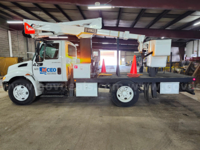 2004 International 4200 bucket truck in serviceable condition showing boom lift and lettering on cab, stock number 11500-234.