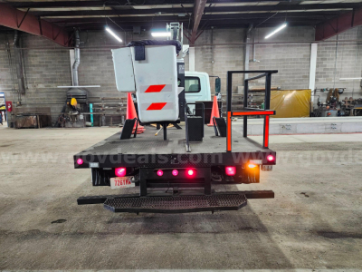 Back of a 2004 International 4200 bucket truck showing rear equipment, lights, and safety cones.