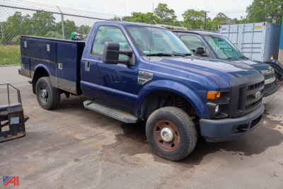 Blue 2008 Ford F-350 Super Duty utility truck with service body, front view angled; dual rear wheels; metal work box on bed; large side steps.