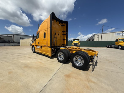 Freightliner Cascadia 126 sleeper cab with yellow paint, side view shows tractor chassis and rear dual wheels; no legible labels visible on image.