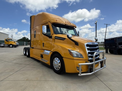 Truck cab showing Freightliner Cascadia 126 in yellow with chrome bumper guard and side mirrors.