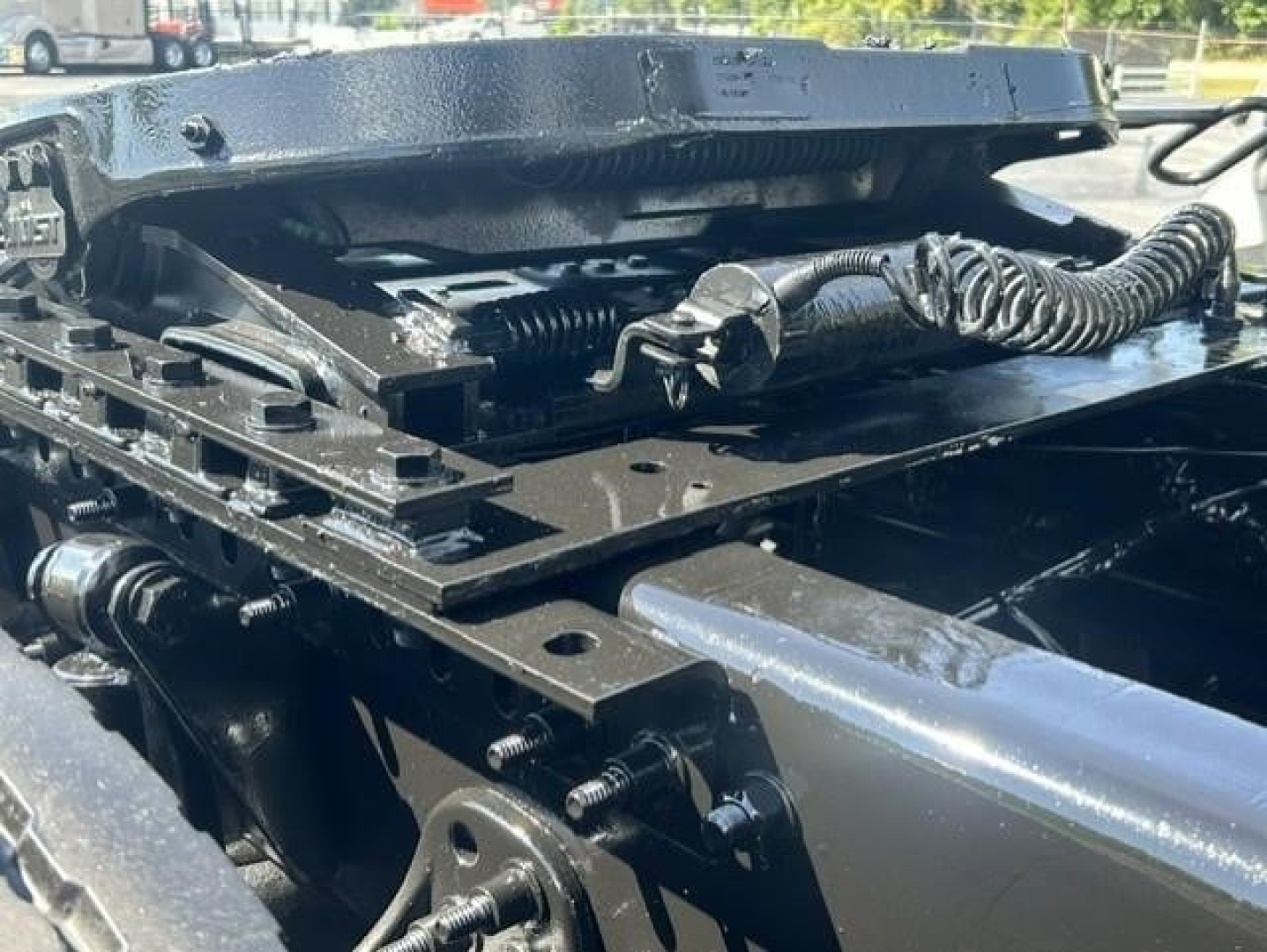 Freightliner Cascadia 126 chassis area showing mounting hardware and hydraulic components beneath the cab.