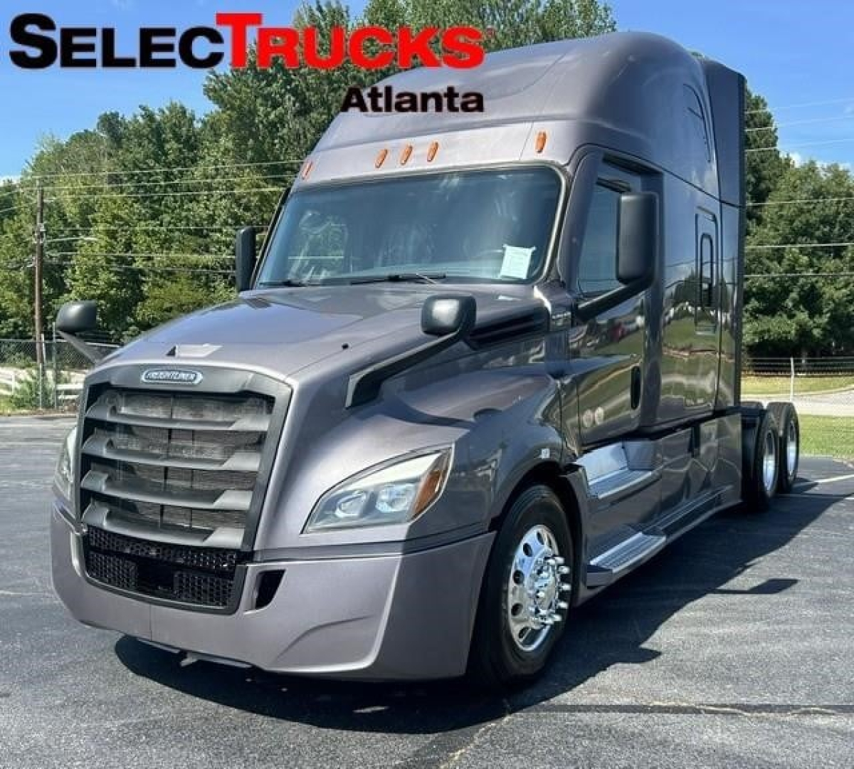Semi truck cab showing front and side view with Freightliner badge, large grille, sleeper cab, and SelectTrucks Atlanta watermark.