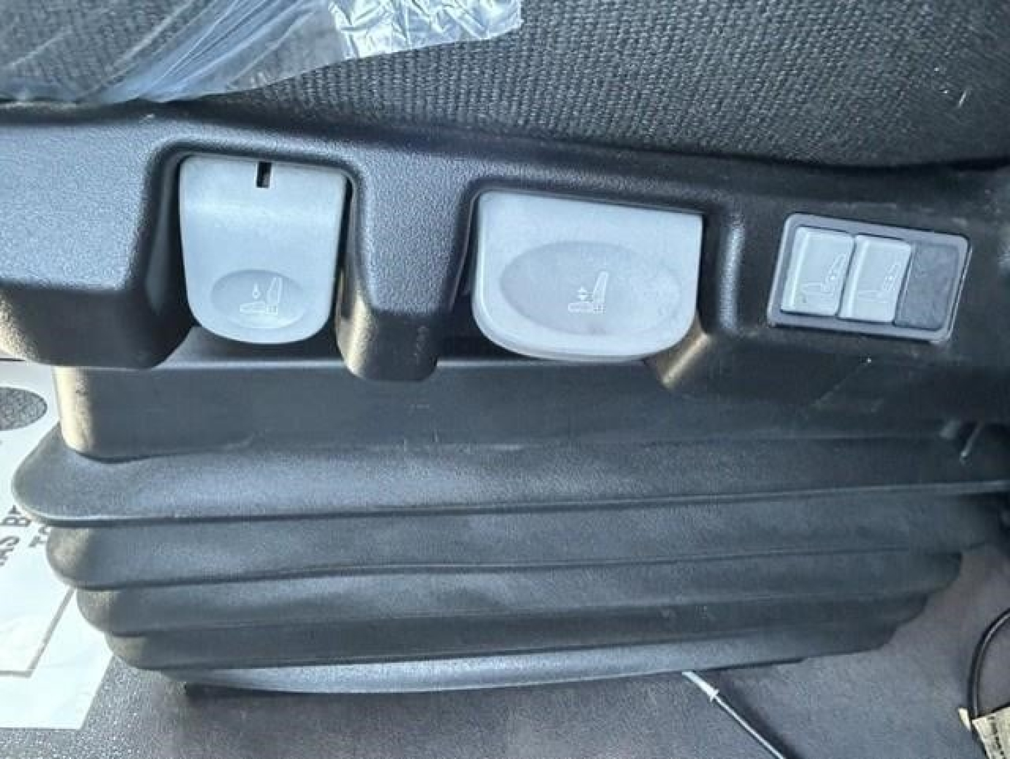 Cabin controls in Freightliner Cascadia showing seat heater switches and a small switch panel.