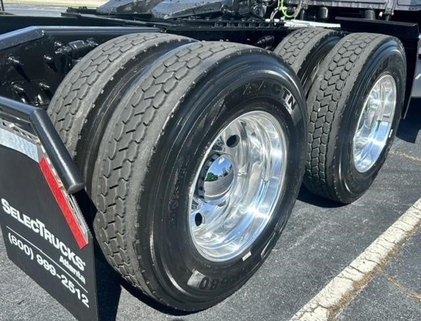 Dual rear truck tires on a Freightliner Cascadia tractor showing chrome wheels and tread pattern.