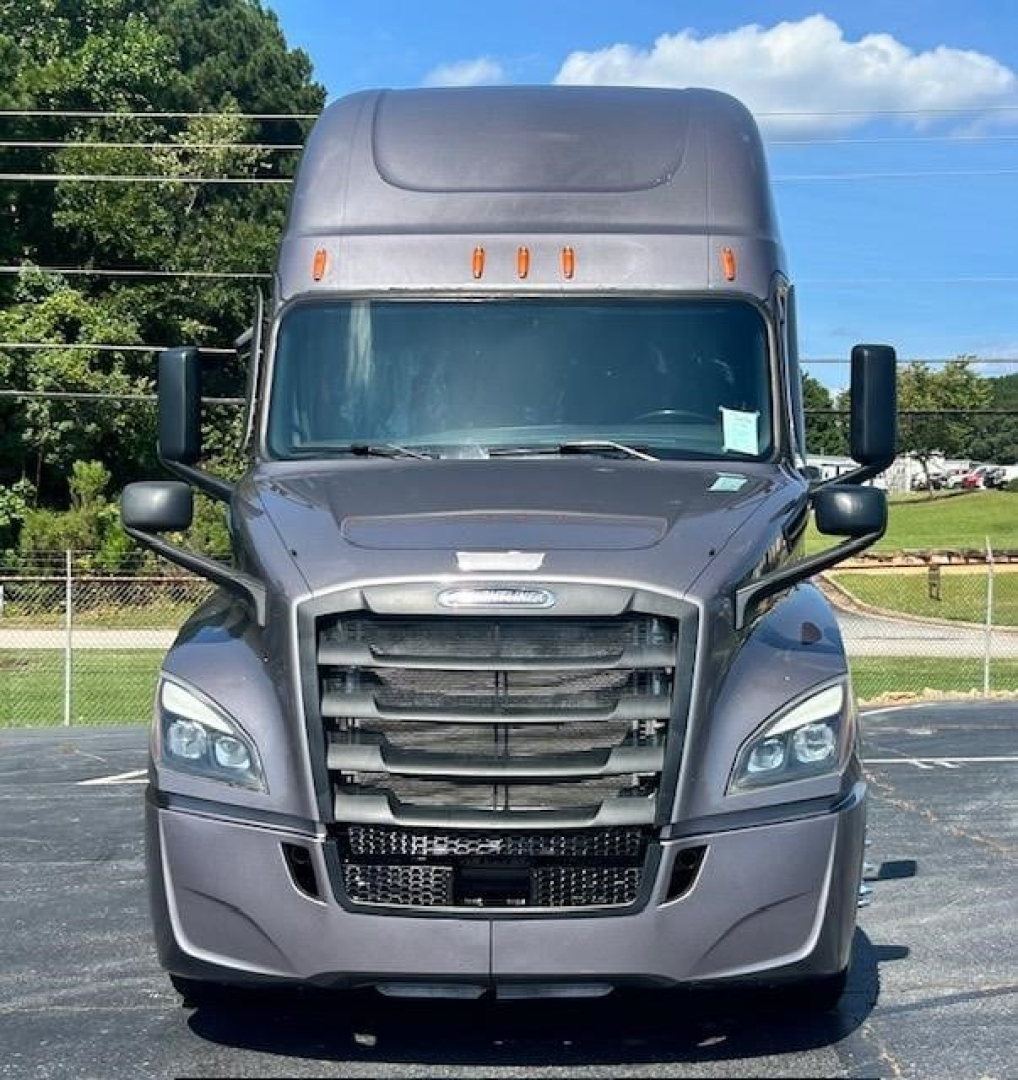 Truck cab front view showing Freightliner Cascadia grille and headlights.