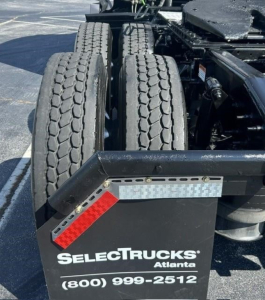 Rear view of a Freightliner Cascadia 126 tractor chassis showing dual rear axles and trailer hookup, with SelectTrucks Atlanta branding and contact number.